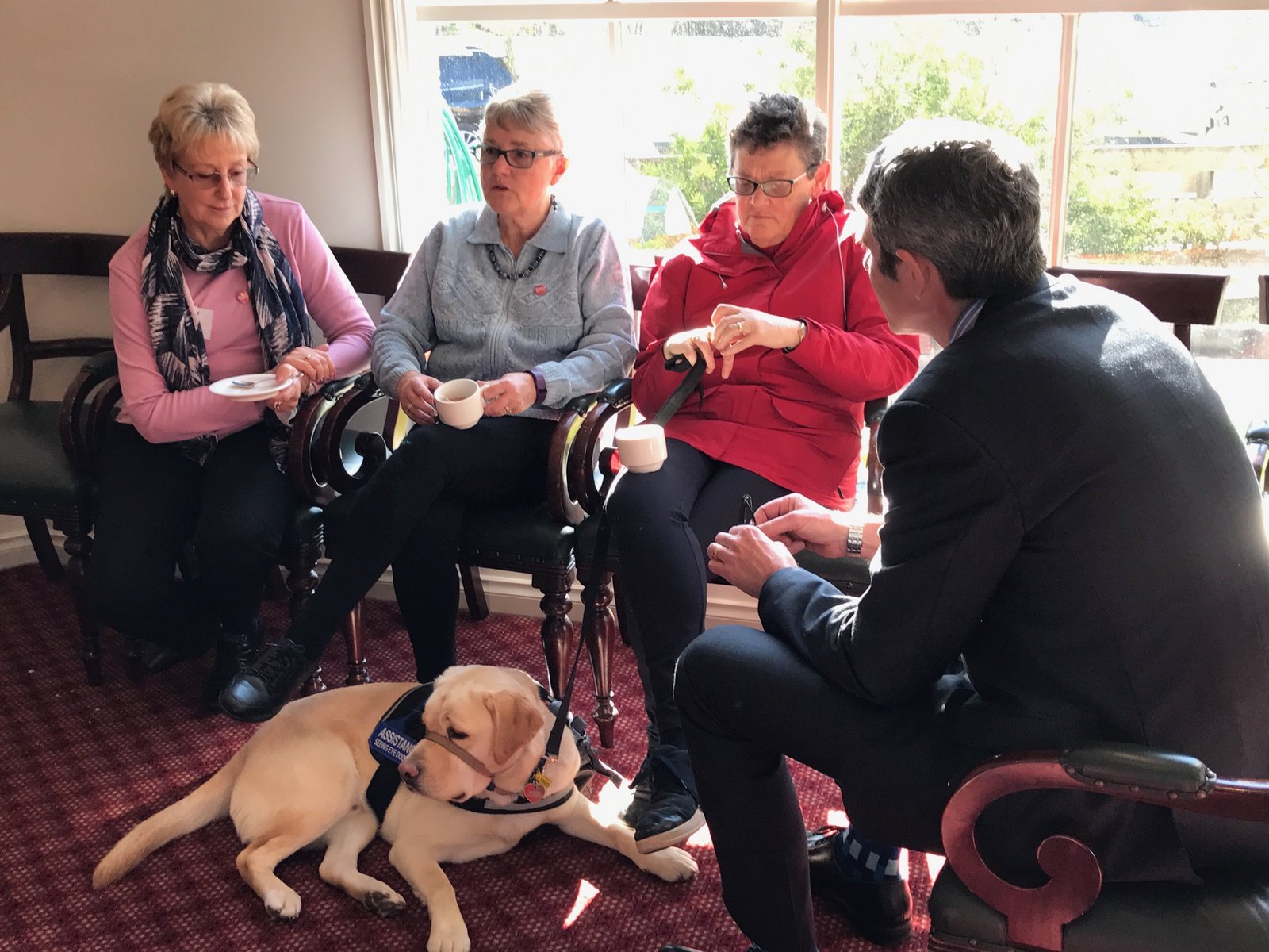 Carers in conversation over tea